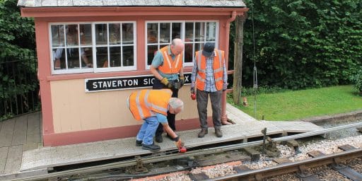 Volunteers of the Signal and Telegraph Gang oiling point rodding at Staverton.